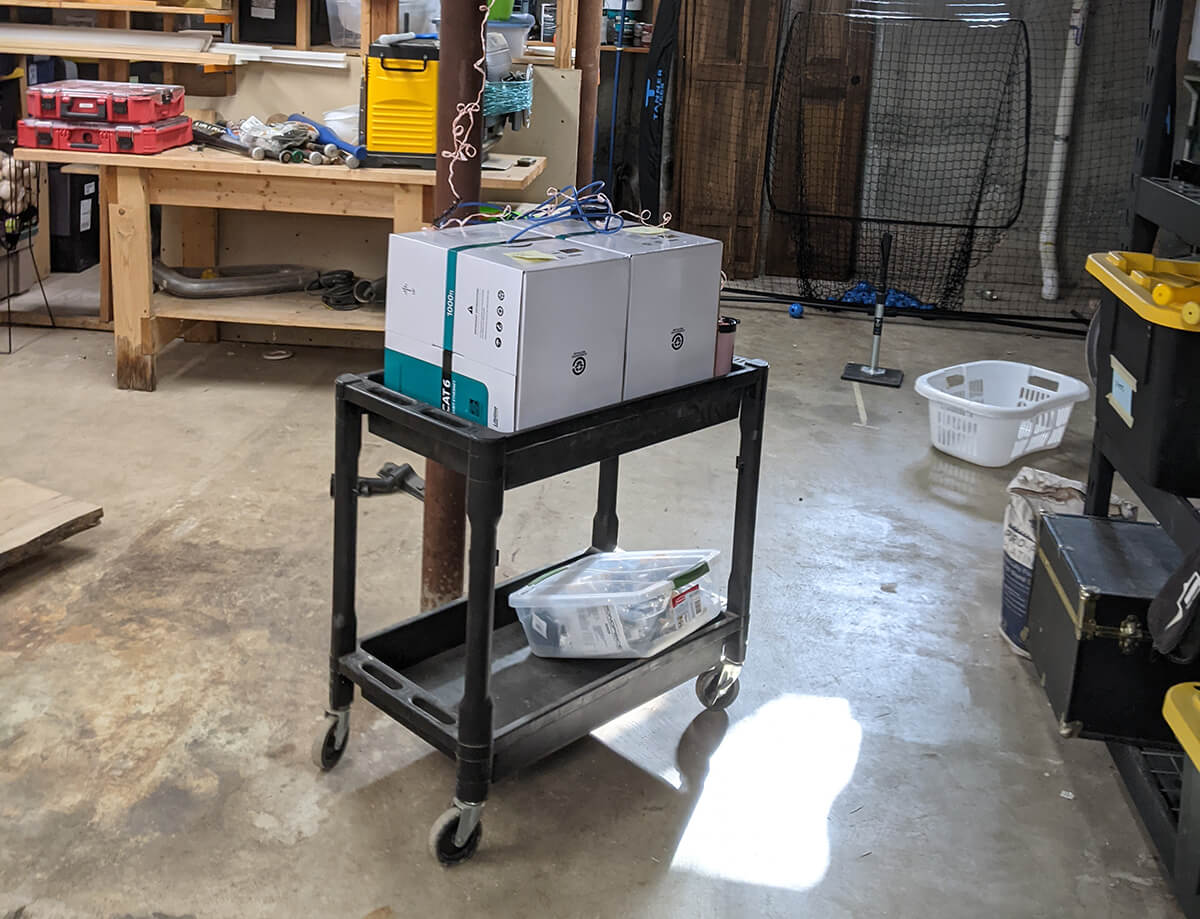 Rolling cart setup with both boxes of ethernet cable ready to start pulling